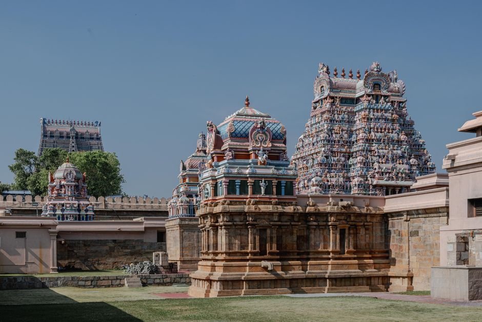 Professor Basavaraja Kodagunti Elected Vice-President of Dravidian Linguistic Association Intricate temple architecture under a clear blue sky in Tamil Nadu, showcasing vibrant sculptures and traditional design.