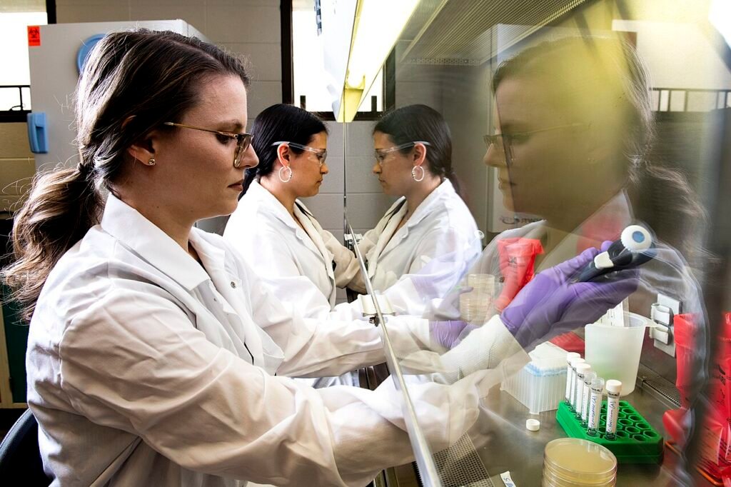 Jennifer Acuff, assistant professor of food safety, and M.S. student Erika Kadas collect Salmonella bacterial cells from agar plates to inoculate low-moisture foods, like milk powder, for thermal ina…