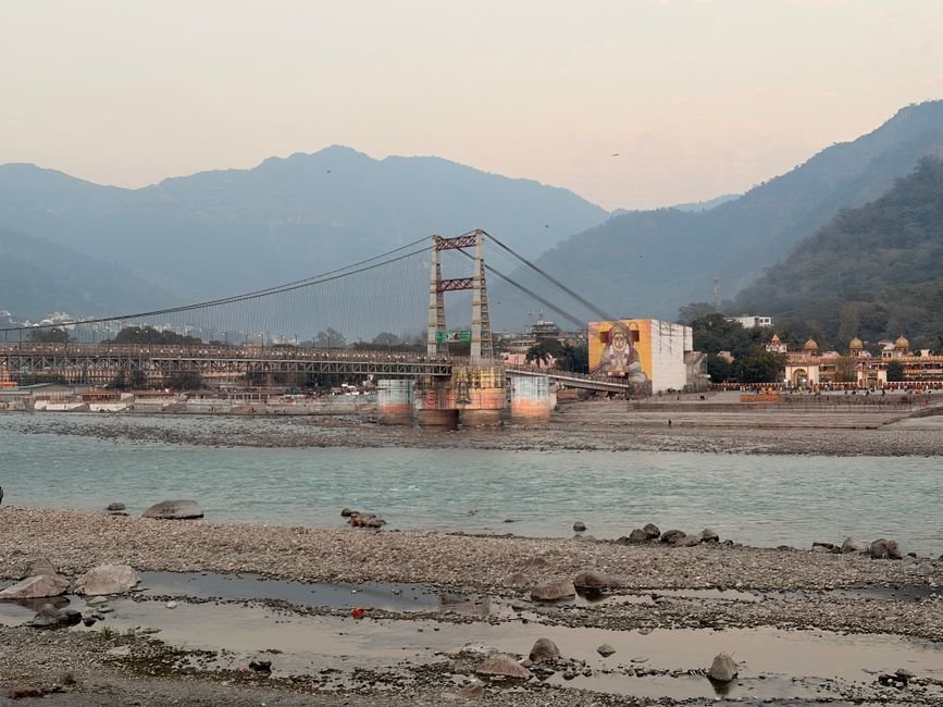 Uttar Pradesh Tannery Regulations Lead to Significant Reduction in Ganga Pollution Laxman Jhula bridge spanning Ganges River in Rishikesh with mountainous backdrop.