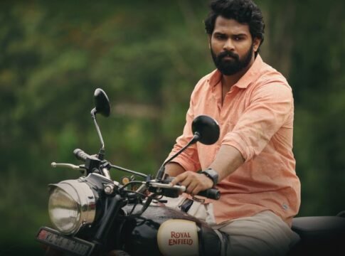 Man in pink shirt riding a Royal Enfield motorcycle outdoors, showcasing adventure and freedom. Man in pink shirt riding a Royal Enfield motorcycle outdoors, showcasing adventure and freedom.