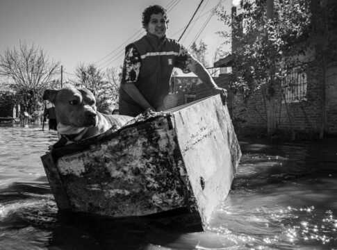 Man rescues dog using a makeshift boat during Buenos Aires flood.