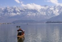 Srinagar Municipal Corporation Assumes Control of Jammu and Kashmir’s First Modern Abattoir Project Peaceful view of Dal Lake in Srinagar surrounded by snowcapped Himalayas, featuring traditional boats.