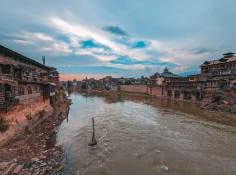 Picturesque cityscape of Srinagar with a view of the Jhelum River at sunset, showcasing historic architecture. Picturesque cityscape of Srinagar with a view of the Jhelum River at sunset, showcasing historic architecture.