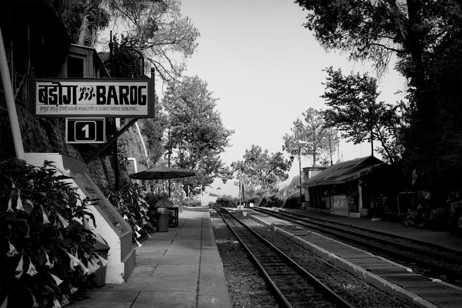 Himachal Pradesh: Barog’s Tranquil Charm Offers Memorable Celebrations Scenic view of Barog Railway Station, Himachal Pradesh, India, captured in stunning black and white.