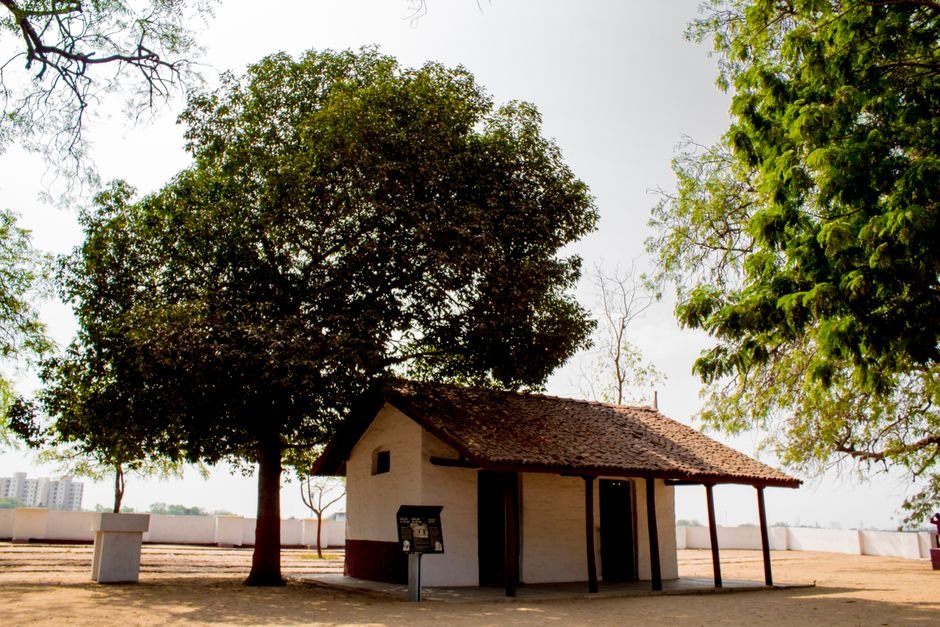 Serene bungalow surrounded by lush trees under a sunny sky, perfect for peaceful retreats.