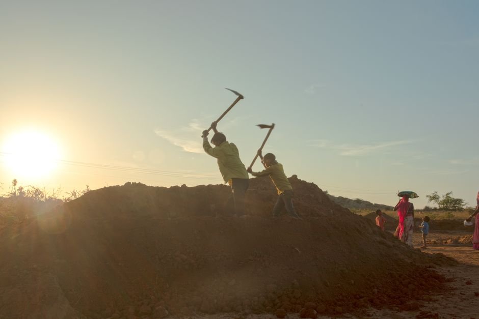 Andhra Pradesh: Vadde Community Members Rescued from Bonded Labour Conditions Silhouetted workers laboring at sundown in a rural Indian field, capturing daily life and environment.