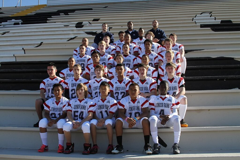 Student-athletes participating in the Junior Academic All-American Game pose for a team photo with coaches at Saguaro High School in Phoenix, Ariz., Dec. 30, 2011. Players participating in the Junior…