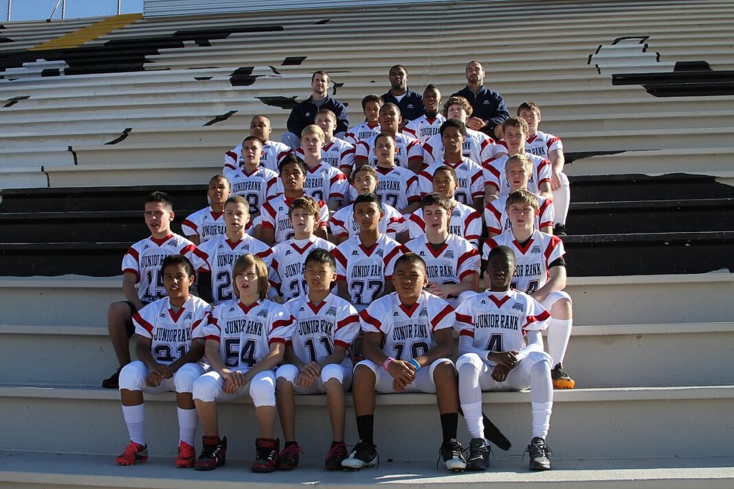 American High School Junior Pursues Track and Field Aspirations Student-athletes participating in the Junior Academic All-American Game pose for a team photo with coaches at Saguaro High School in Phoenix, Ariz., Dec. 30, 2011. Players participating in the Junior…