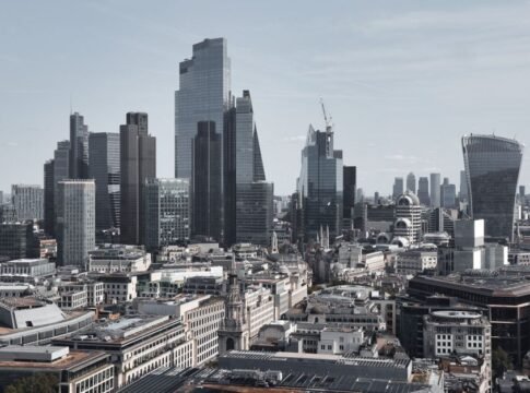 Stunning aerial view of London's financial district featuring modern skyscrapers under a clear sky.