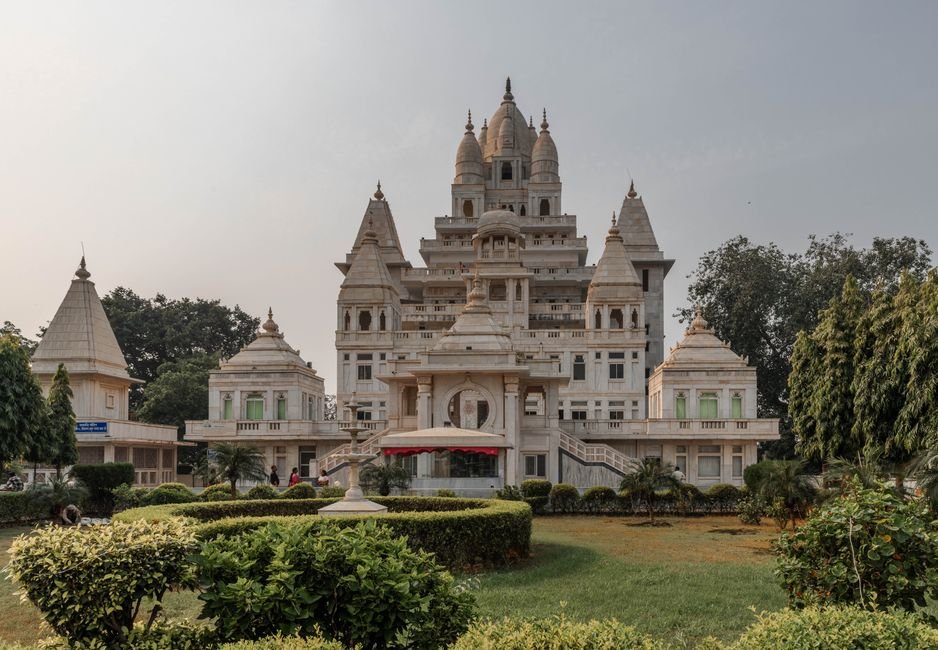 Uttar Pradesh Government Job Aspirants Face Prolonged Delays, Risking Prime Career Years Stunning view of a temple in Vrindavan, showcasing intricate architecture and lush gardens.