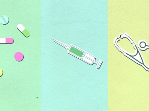 Top view of decorative cardboard appliques representing assorted medications near syringe with vaccine and stethoscope Top view of decorative cardboard appliques representing assorted medications near syringe with vaccine and stethoscope