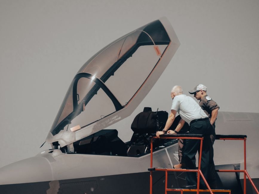 India Joins Elite Space Club as Skyroot Aerospace Successfully Launches Vikram-1 Two men inspecting military aircraft cockpit on a clear day.