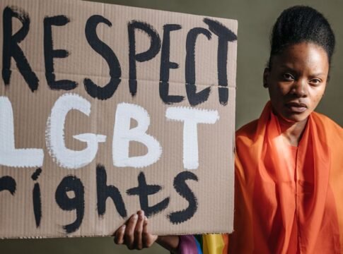 Woman holding a sign advocating for LGBT rights, highlighting social justice. Woman holding a sign advocating for LGBT rights, highlighting social justice.