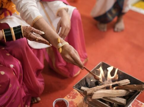 A Hindu bride and groom participate in a sacred fire ceremony, symbolizing eternal unity. A Hindu bride and groom participate in a sacred fire ceremony, symbolizing eternal unity.
