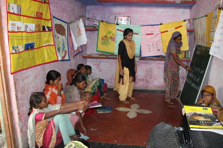 Ludhiana Teacher’s Door-to-Door Efforts Boost Attendance in Single-Teacher School A group of Indian girls engaged in a classroom learning environment indoors.