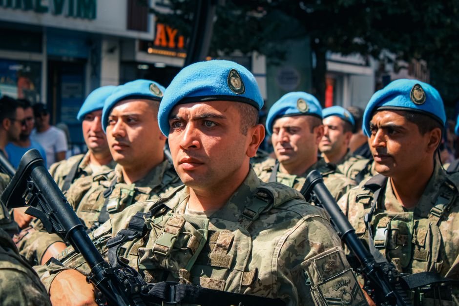Jammu and Kashmir: Search Operation Underway in Poonch Forests Following Suspicious Movement A group of soldiers in blue berets marching during a daytime military parade in the city.