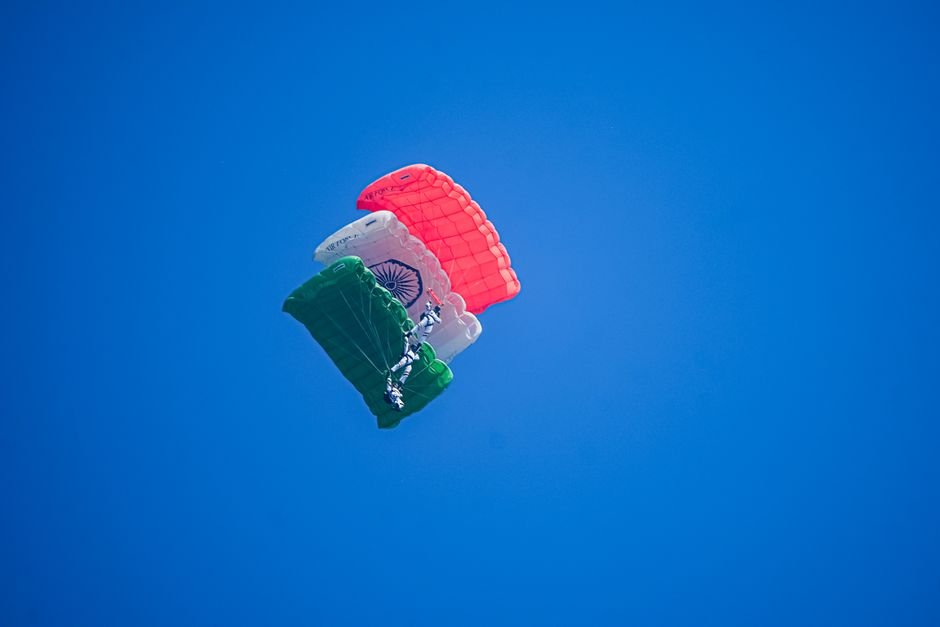Northern Army Commander Reviews Security Preparedness in South Kashmir A skydiver descends with an Indian flag parachute against a bright blue sky, symbolizing adventure and patriotism.
