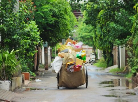 A street cart full of recyclable items on a lush, green street in Ludhiana, India.