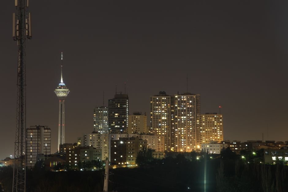 A stunning night view of Tehran's skyline with the iconic Milad Tower prominently visible.