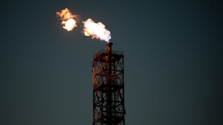 Government Mandates LPG Production Targets for Refiners; Reliance Assigned Largest Quota A towering industrial chimney with a dramatic flame against a dark sky in Salina Cruz, Mexico.