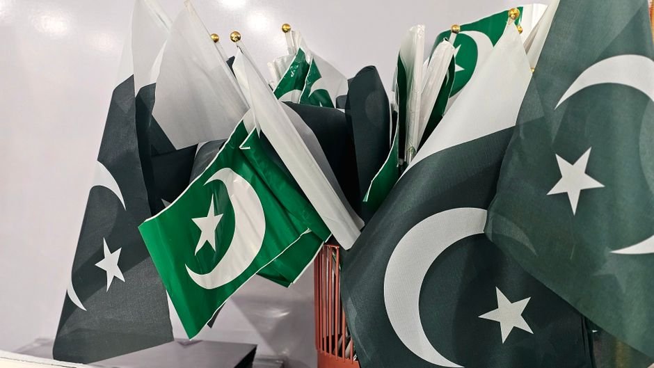 Pakistan Summons US Chargé d’Affaires Over Jammu and Kashmir Remarks A variety of Pakistani flags grouped together indoors, emphasizing national pride.