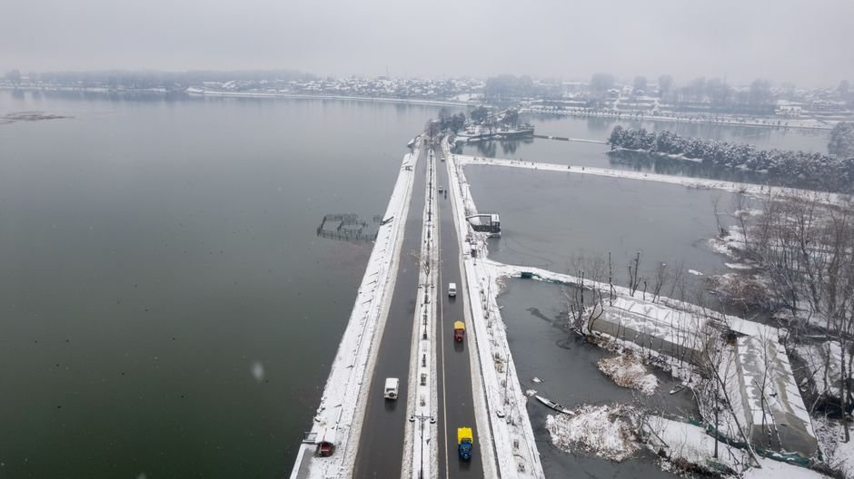 Jammu and Kashmir: 18 Civil Service Officers Nominated for IAS Promotion Aerial shot of a snow-covered bridge and road in Srinagar, Kashmir, during winter.