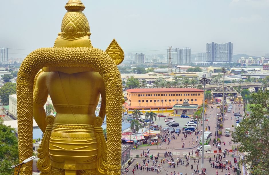 Quit India Movement’s Legacy Inspires Generations, Says Union Minister L. Murugan Aerial view of Batu Caves with the golden Murugan statue and Kuala Lumpur cityscape beyond.