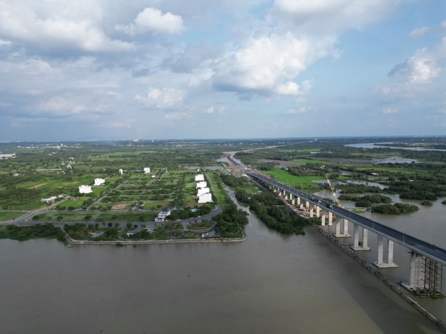 Andhra Pradesh Minister Reviews Progress of Key Amaravati Buildings Aerial view of bridge over a river surrounded by lush greenery in Dong Nai, Vietnam.