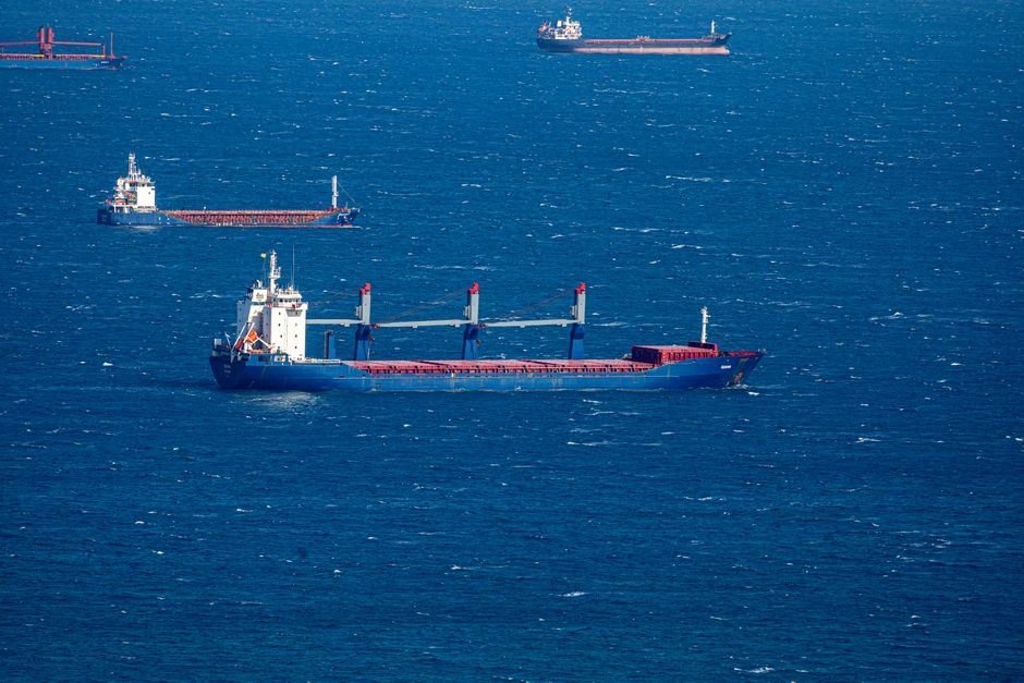 Two Vessels With 22 Indian Nationals Hijacked Off Yemen and Somalia Aerial view of multiple cargo ships navigating through the vast blue ocean, capturing maritime commerce.