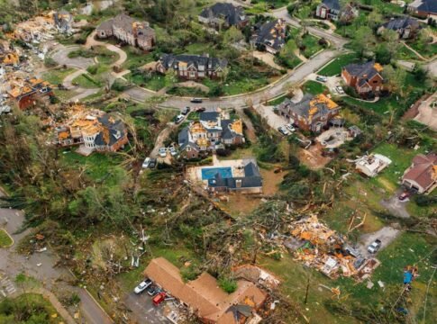 Aerial view of small settlement with destroyed houses and bent uprooted trees after hurricane