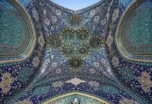 Iran Security Chief Issues Stark Warnings to Neighbors Amidst Mideast Tensions Bottom view of the iwan at one of the entrances at Fatima Masumeh Shrine, Qom, Iran. this picture merged from 25 pictures. 5 frames and each frame contain 5 pictures with 5 levels of exposure. HDR + …