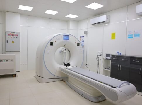 Bright and sterile hospital imaging room featuring a state-of-the-art CT scanner. Bright and sterile hospital imaging room featuring a state-of-the-art CT scanner.