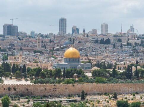 Captivating aerial view of the Dome of the Rock with Jerusalem's skyline in the background. Captivating aerial view of the Dome of the Rock with Jerusalem's skyline in the background.