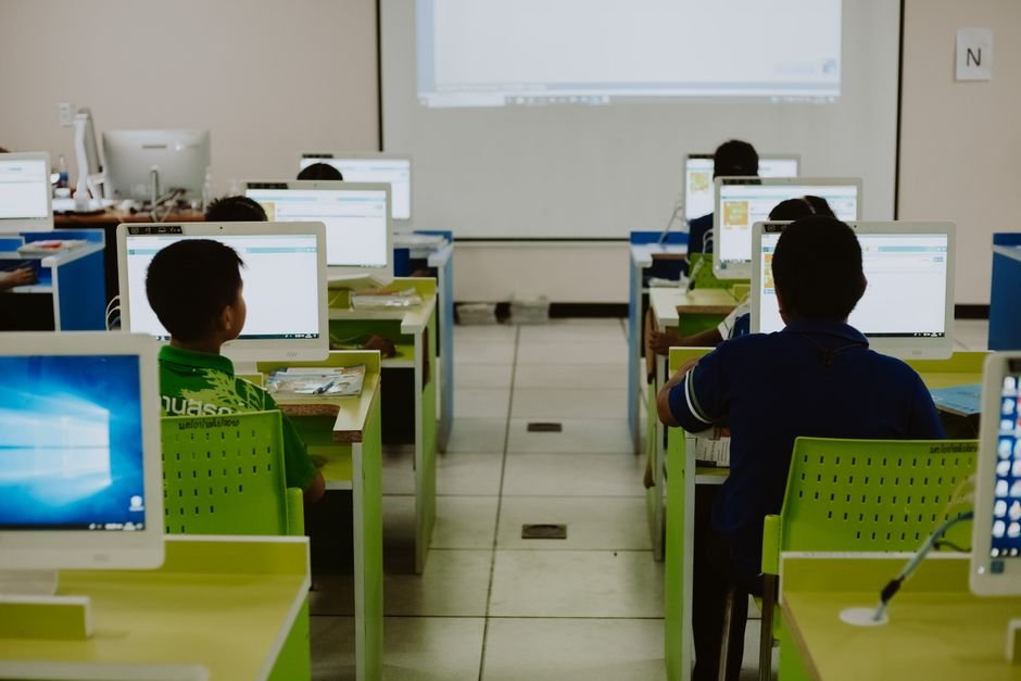 Punjab CM Mann to Inaugurate Schools of Eminence in Ludhiana Children focus on computers in a modern classroom setting.