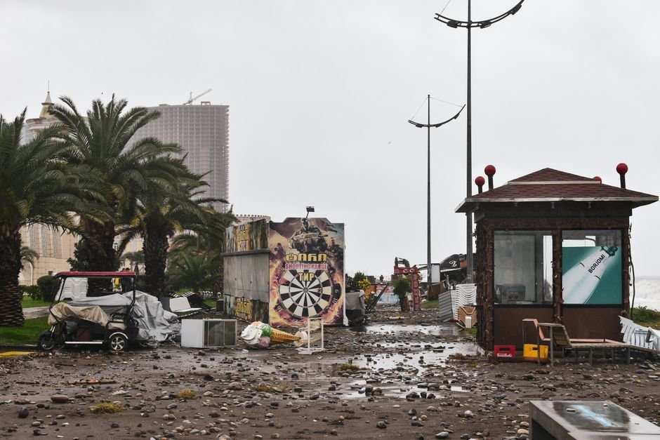 Hurricane Lala Batters Hawaii with Torrential Rain, Damaging Winds, and Coastal Flooding City street filled with storm debris and damaged structures under a cloudy sky.