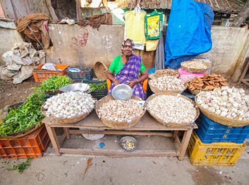 Colorful street market scene of a senior vendor selling vegetables in Cumbum, India. Colorful street market scene of a senior vendor selling vegetables in Cumbum, India.