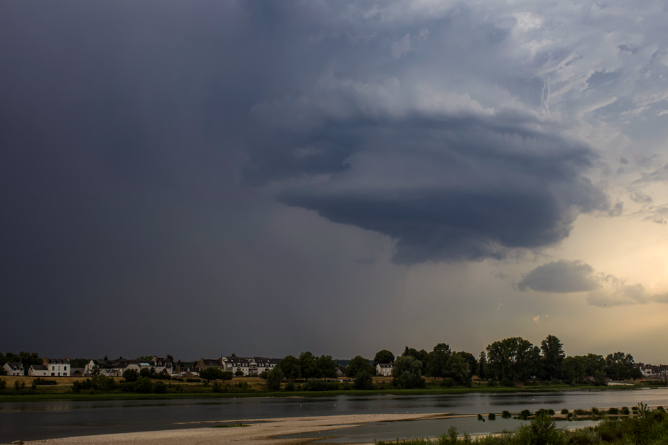Himachal Pradesh Faces Continued Heavy Rainfall, Yellow Alert Issued for All Districts Dark supercell cloud formation over a city skyline with dramatic lighting, showcasing powerful weather.