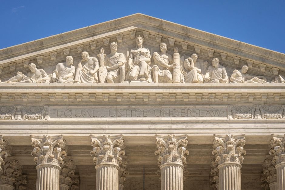 Rajasthan, Uttar Pradesh School Entry Restrictions Challenged in Supreme Court Detailed view of the Supreme Court Building's frontal frieze depicting historical figures and justices.