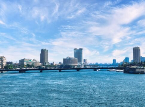 Discover the stunning Cairo skyline with the serene Nile River and a clear blue sky backdrop.