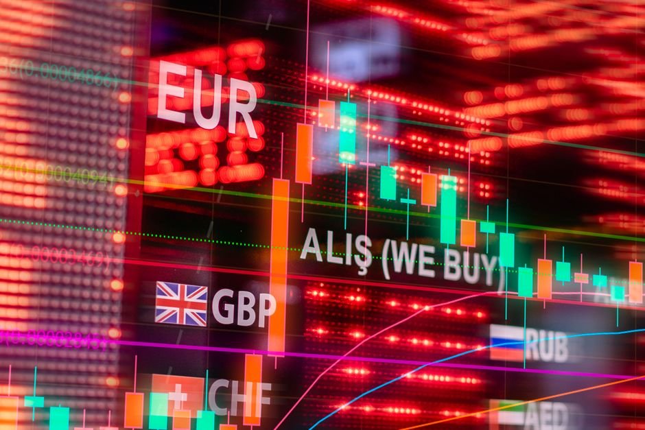 Six Months of Conflict: Iran War’s Global Economic Shockwaves Continue Dynamic forex trading concept with currency symbols and candlestick chart illuminated on screen.