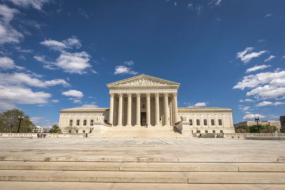 Supreme Court Directs JioStar to Pursue Telecom Dispute at Delhi High Court Front view of the United States Supreme Court building on a sunny day with blue sky and clouds.