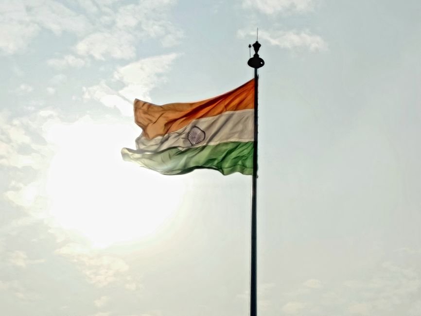 Ferozepur Court Evacuated Amid Bomb Threat Ahead of Independence Day Indian national flag waving on flagpole against a bright sky with clouds.