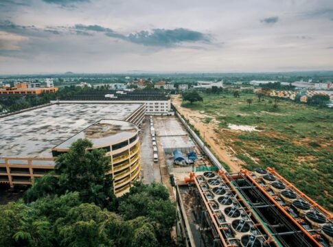 Industrial complex with adjacent greenery, highlighting cityscape and infrastructure. Industrial complex with adjacent greenery, highlighting cityscape and infrastructure.