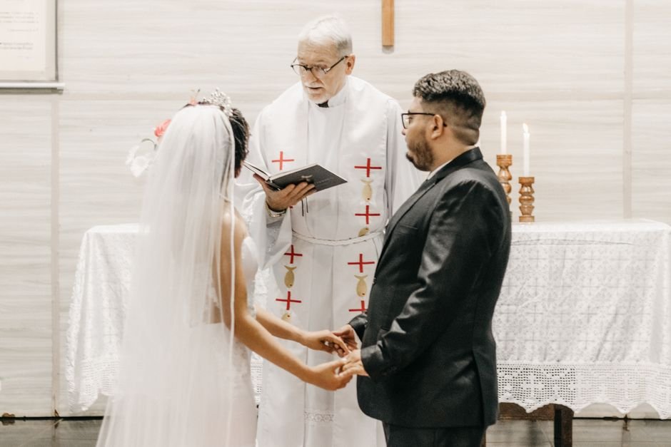 India Reviews H1N1 Preparedness, Emphasizes Vigilance Amidst Seasonal Flu Concerns Newlyweds hold hands during a church ceremony led by a priest.