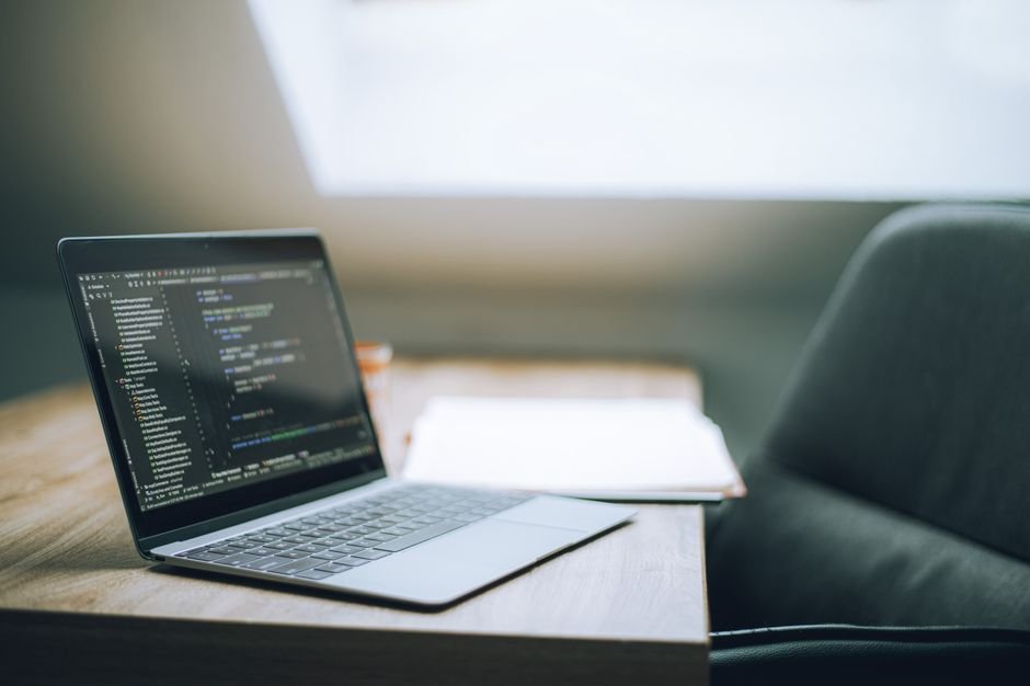 Jammu and Kashmir: 786 Trained in AI Under FutureSkills PRIME, 416 Certified Open laptop displaying code on desk in bright, modern office setting. Ideal for tech and remote work context.