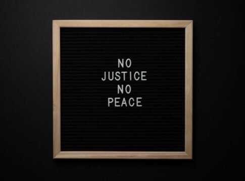 Overhead view of white inscription on center of chalkboard located on black background