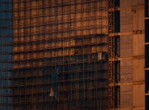 Scaffolding and incomplete building structure at sunset in Noida, India. Scaffolding and incomplete building structure at sunset in Noida, India.