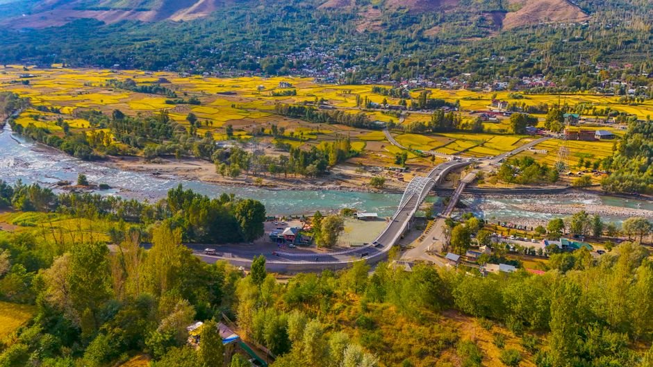 Jammu and Kashmir: Cloudburst Triggers Flash Floods in Kulgam Streams Scenic aerial view of the vibrant Ganderbal Valley and Wayil Bridge in Kashmir.
