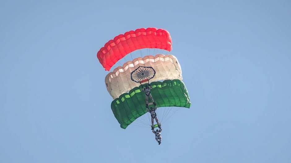 India’s Space Sector: ISRO and Private Industry Collaborating for Future Missions, Says Minister Skydivers displaying Indian flag colors in an aerial stunt in Bengaluru.