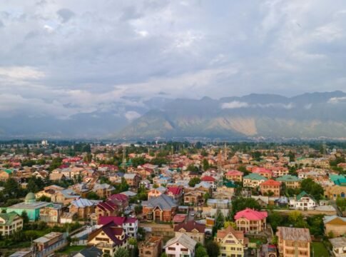 Stunning aerial view of colorful Srinagar city with Himalayan backdrop under cloudy skies. Stunning aerial view of colorful Srinagar city with Himalayan backdrop under cloudy skies.